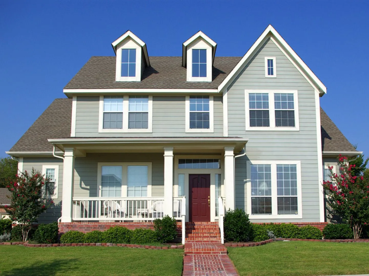 A large house with many windows and a red door